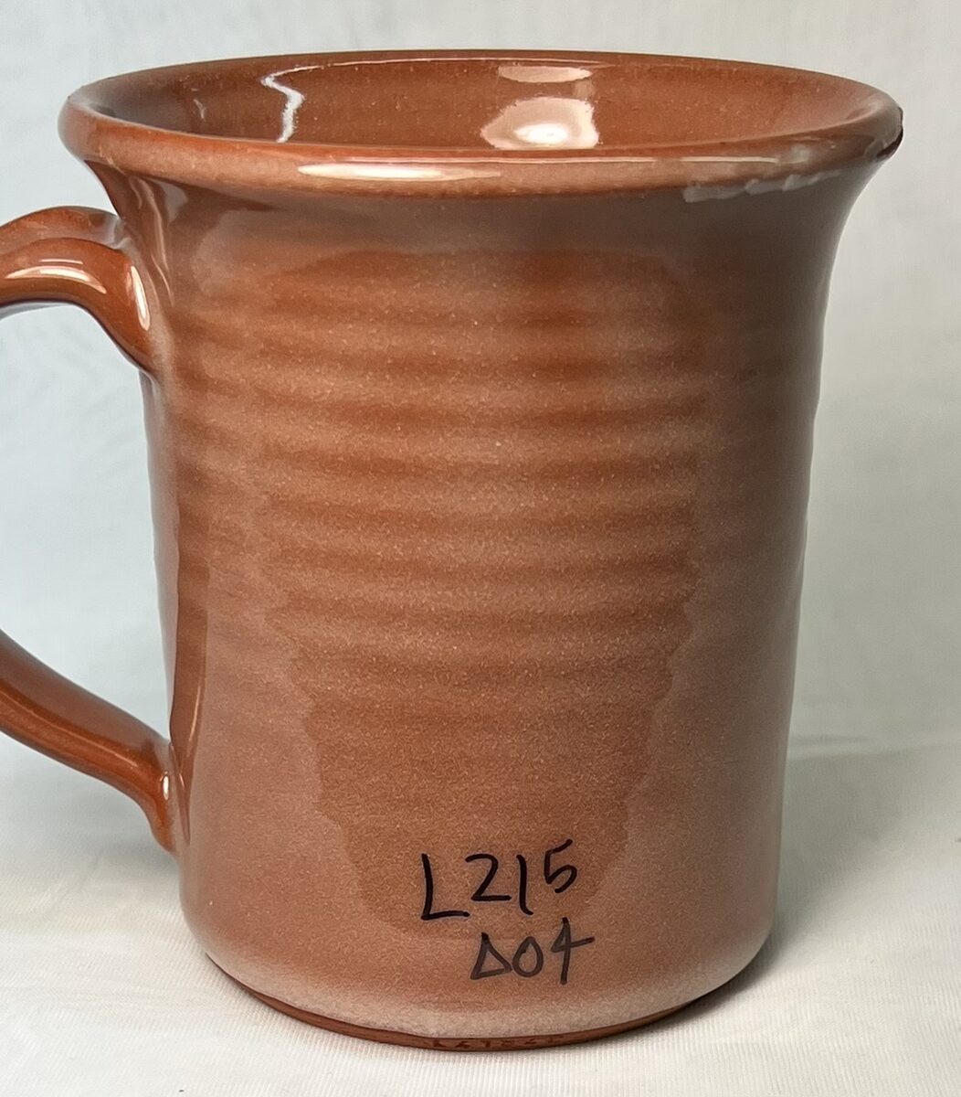A terra cotta mug with glossy transparent glaze