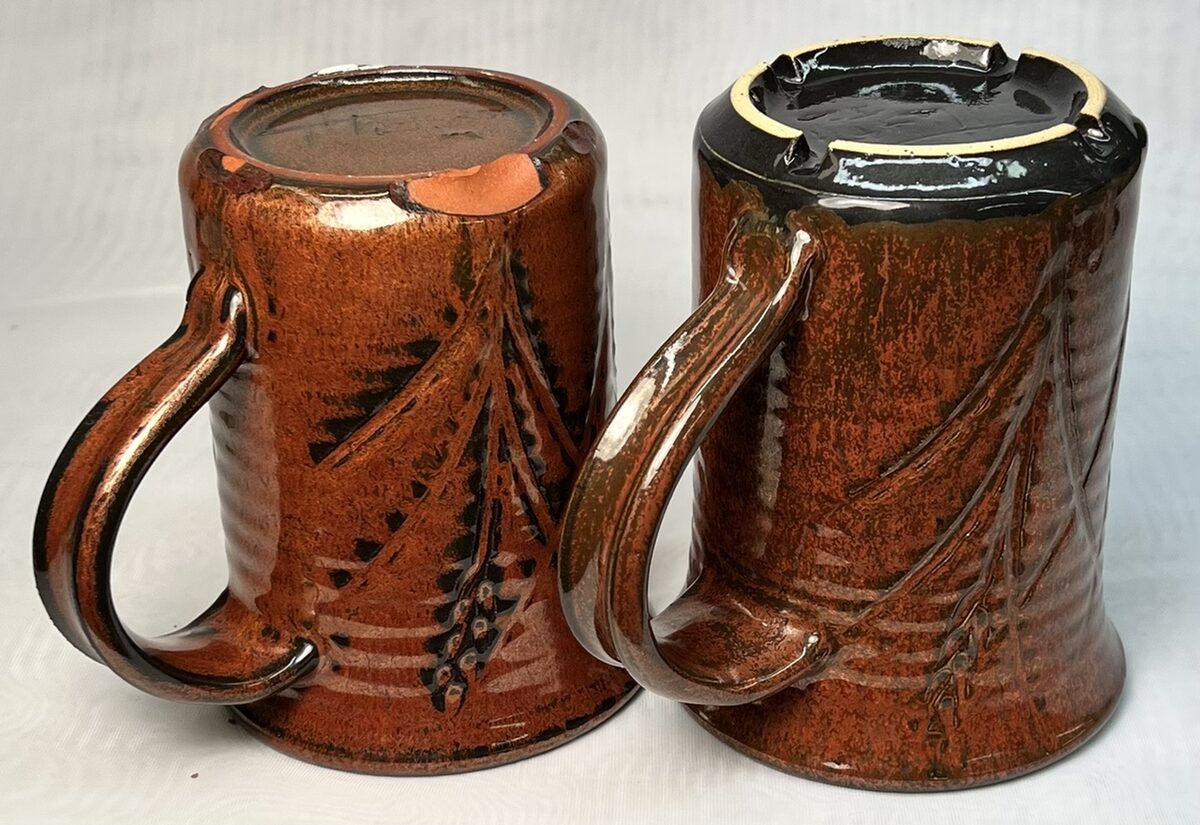 Two iron red mugs