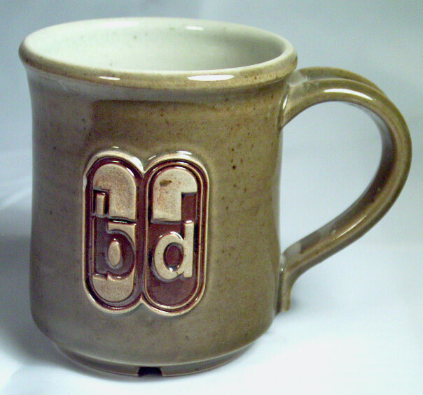 A letterpress stamped logo on a pottery mug A mug with an embosses logo make by a letterpress stamp