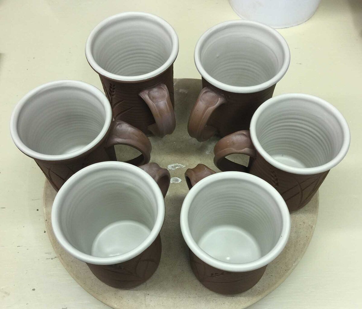 Leather hard mugs with waxed handles