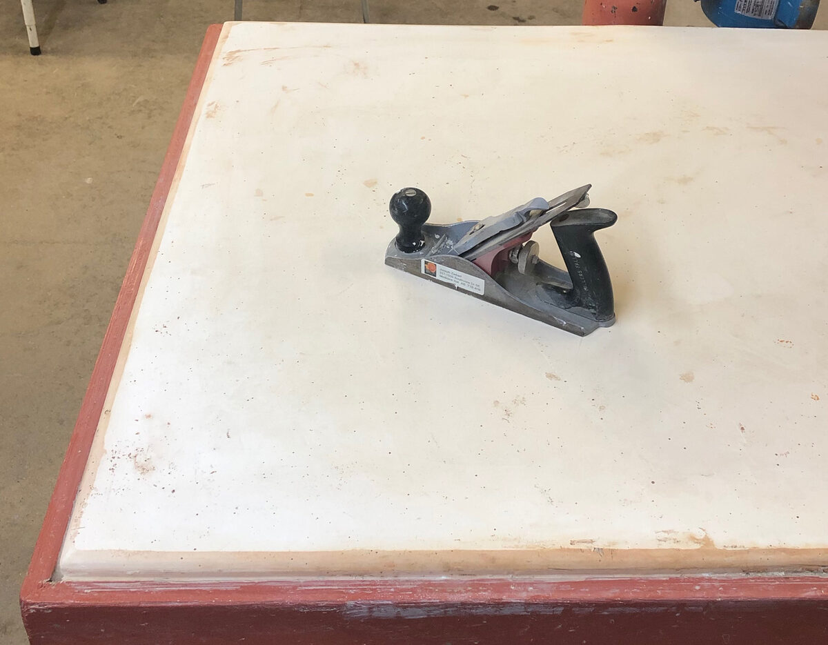 A plaster table and a capenter's plane