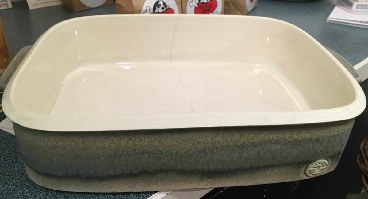 A casserole dish with a dunting crack going down from the rim
