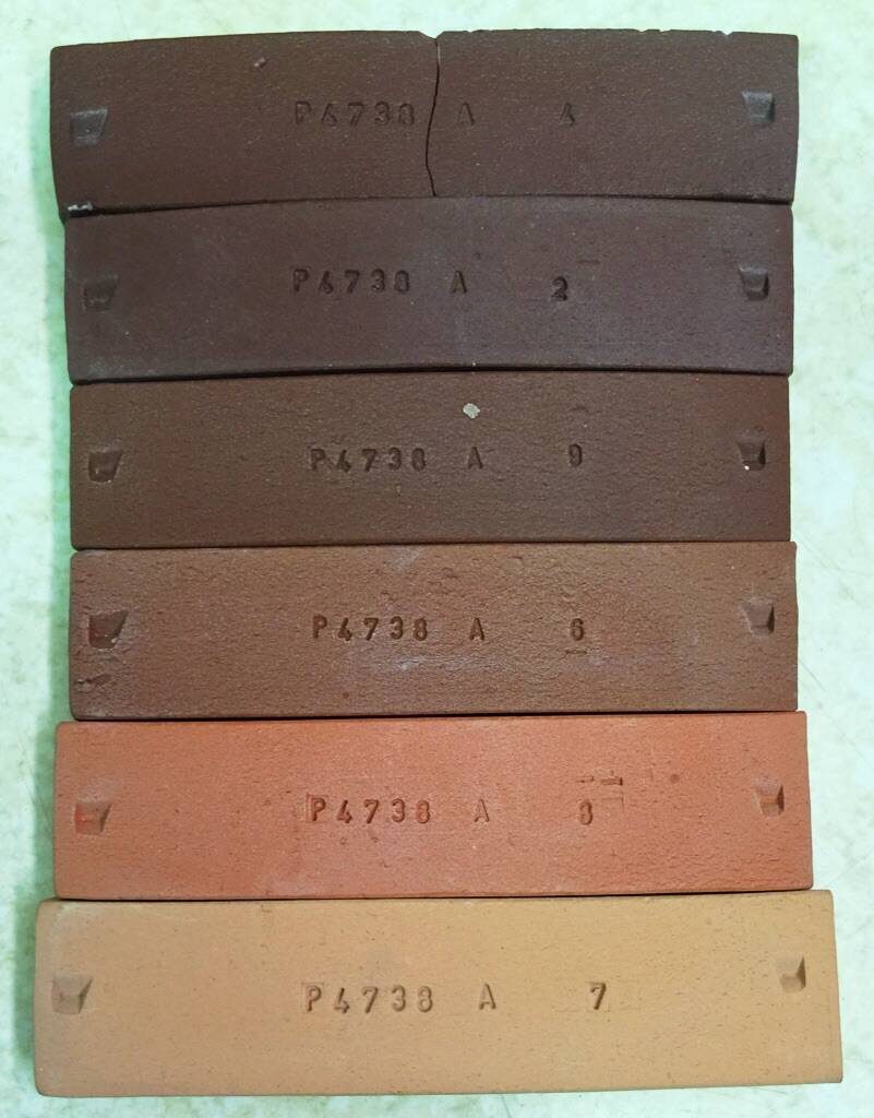 Fired bars of a terra cotta clay fired from cone 06 (bottom) to 4