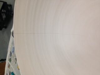 A large pottery bowl with a hairline crack down from the rim