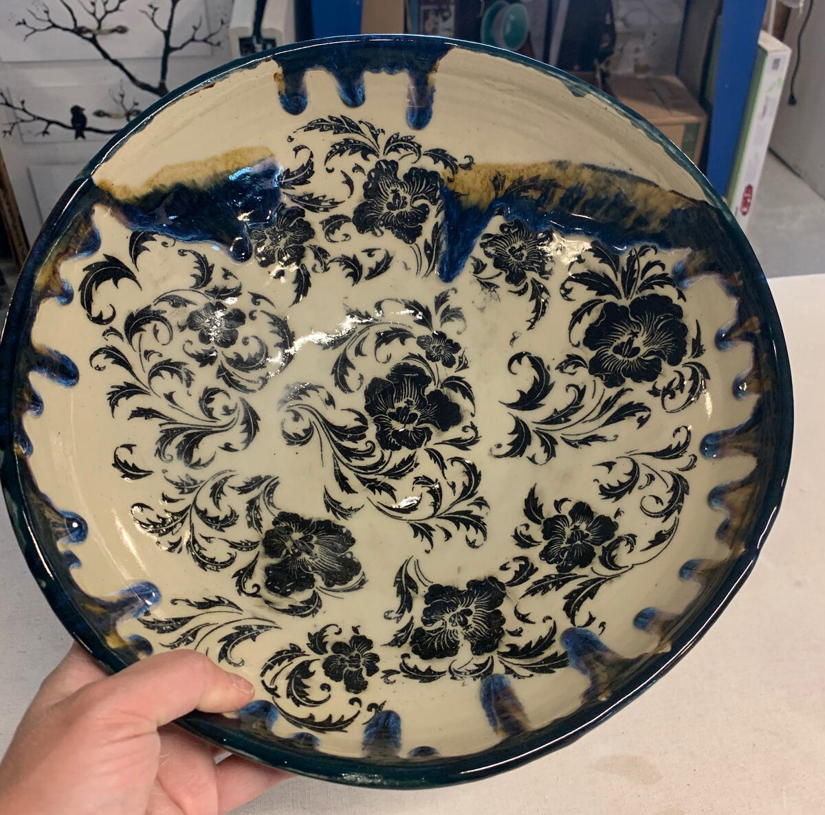 The inner glaze has curtained off downward from the rim on buff stoneware bowl