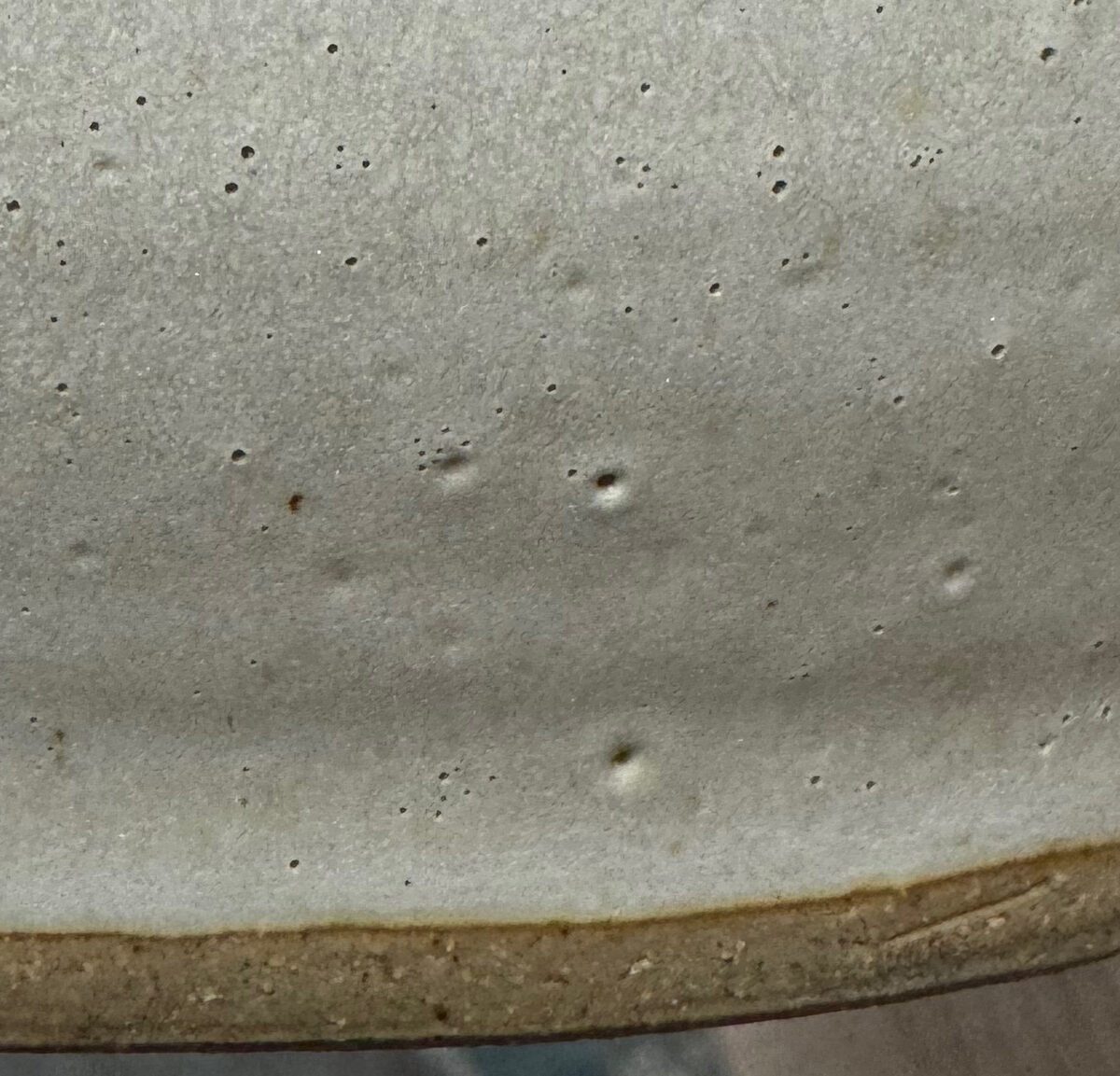 Barium carbonate bubbles in a glaze