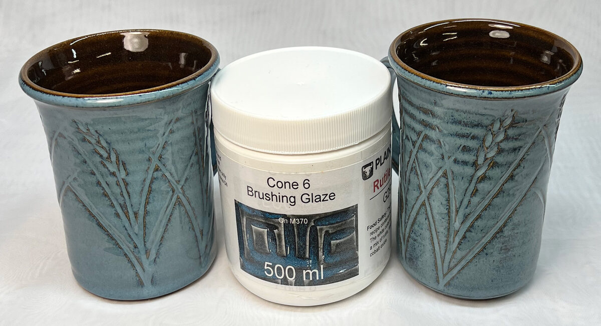 Dipping and brushed glaze on two mugs