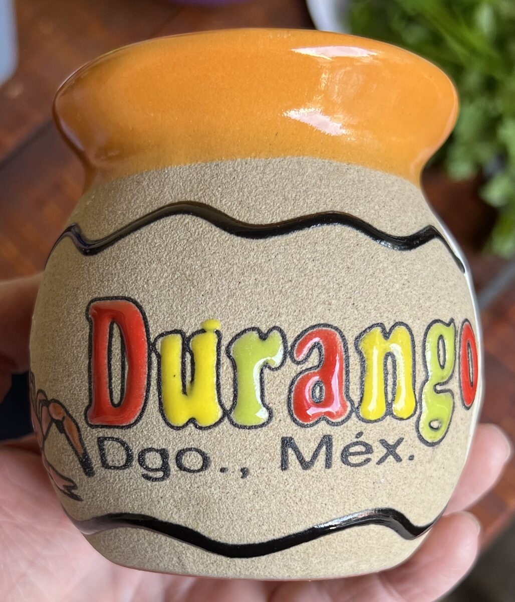 A cuerda seca decorated souvenir mug