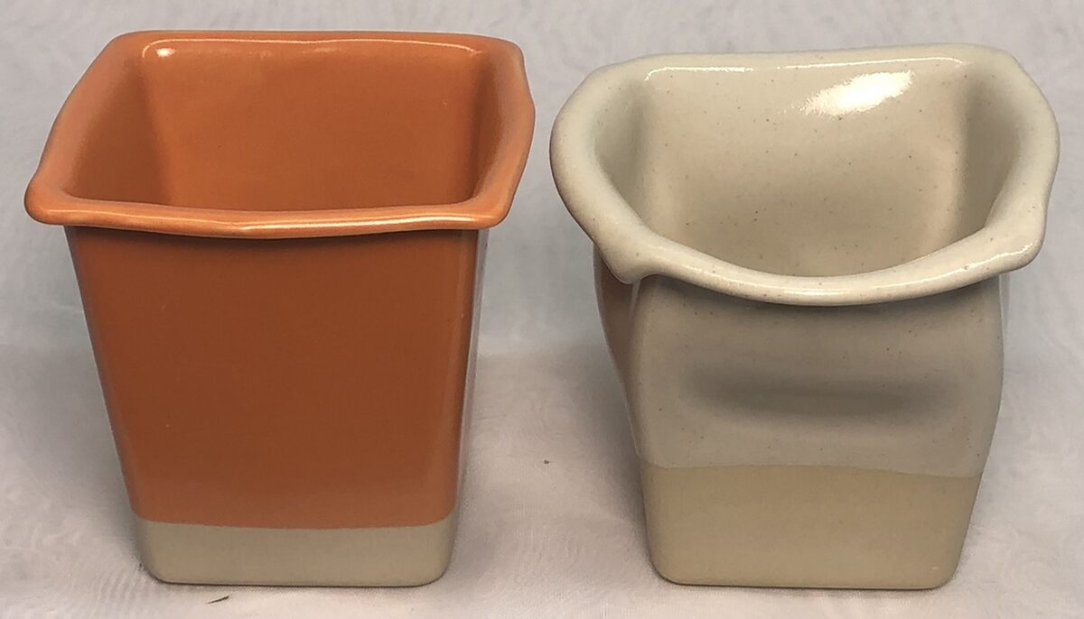 Two warped small square planter shapes