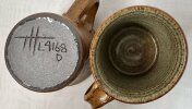 Two warping pottery mugs