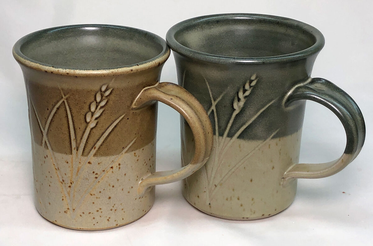 The outer glaze on the mug on the left has 1% iron added, the other does not. Two mugs. One fires a rich brown over the black engobe because it has 1% iron added.