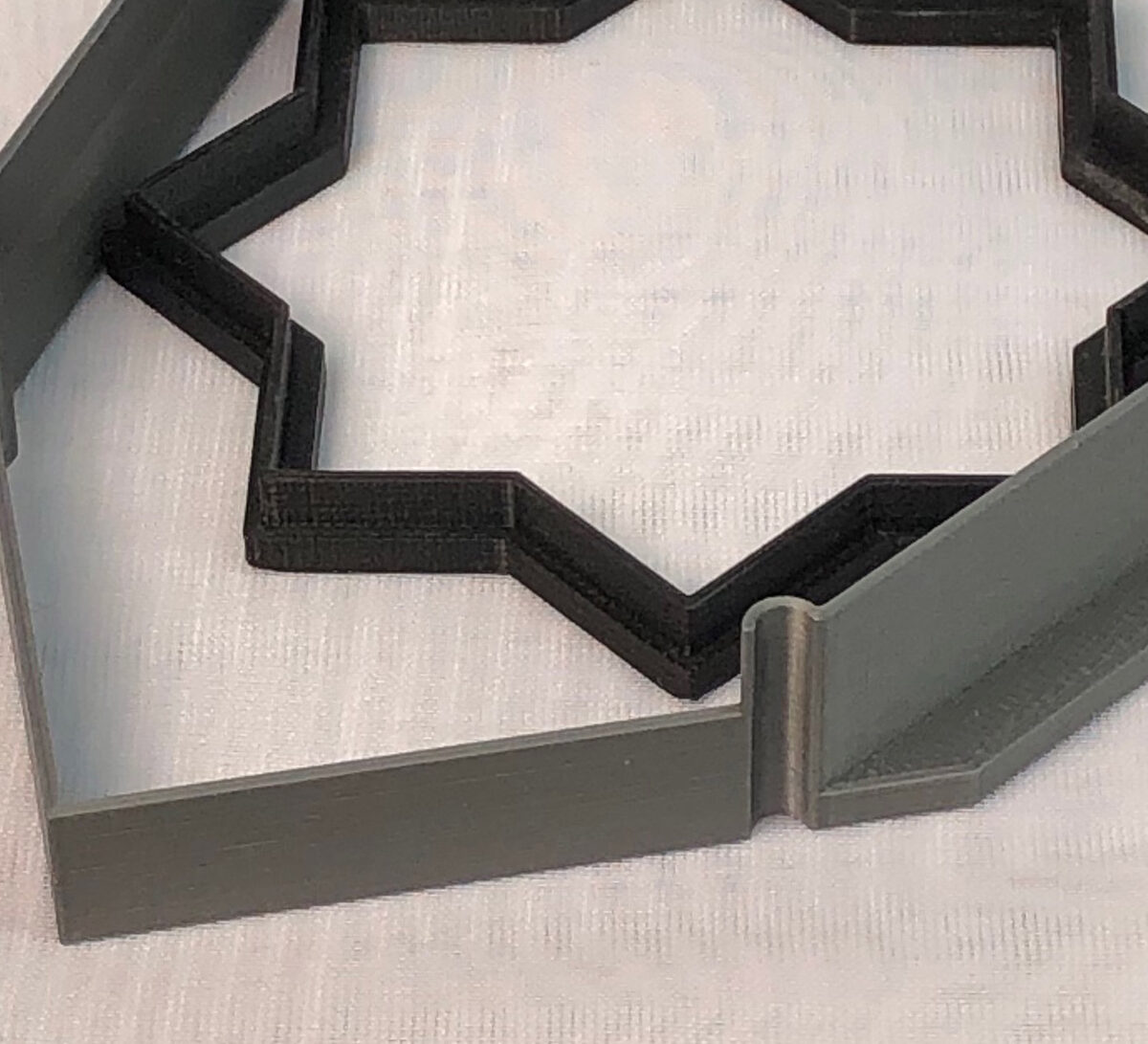 Two 3D printed cookie cutters, the one laminates the walls