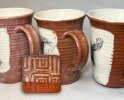 Terra cotta mugs with cloudy glazes