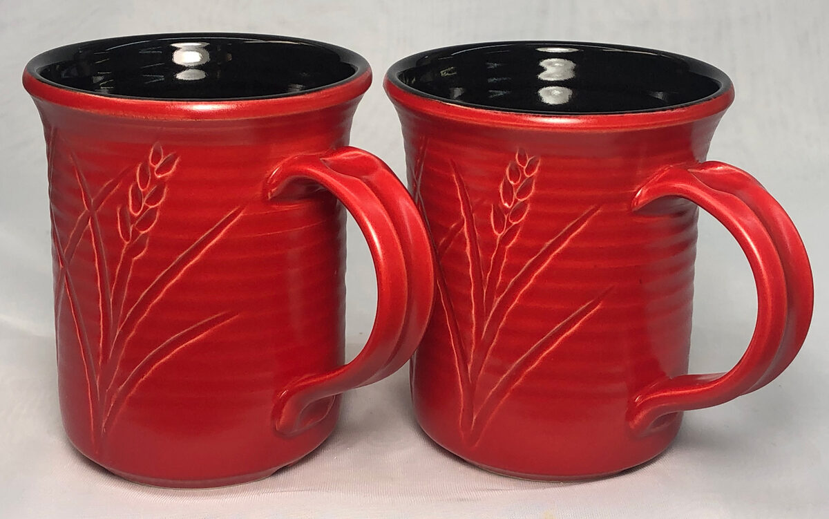 Two mugs, black glaze on the inside, red glaze on the outside