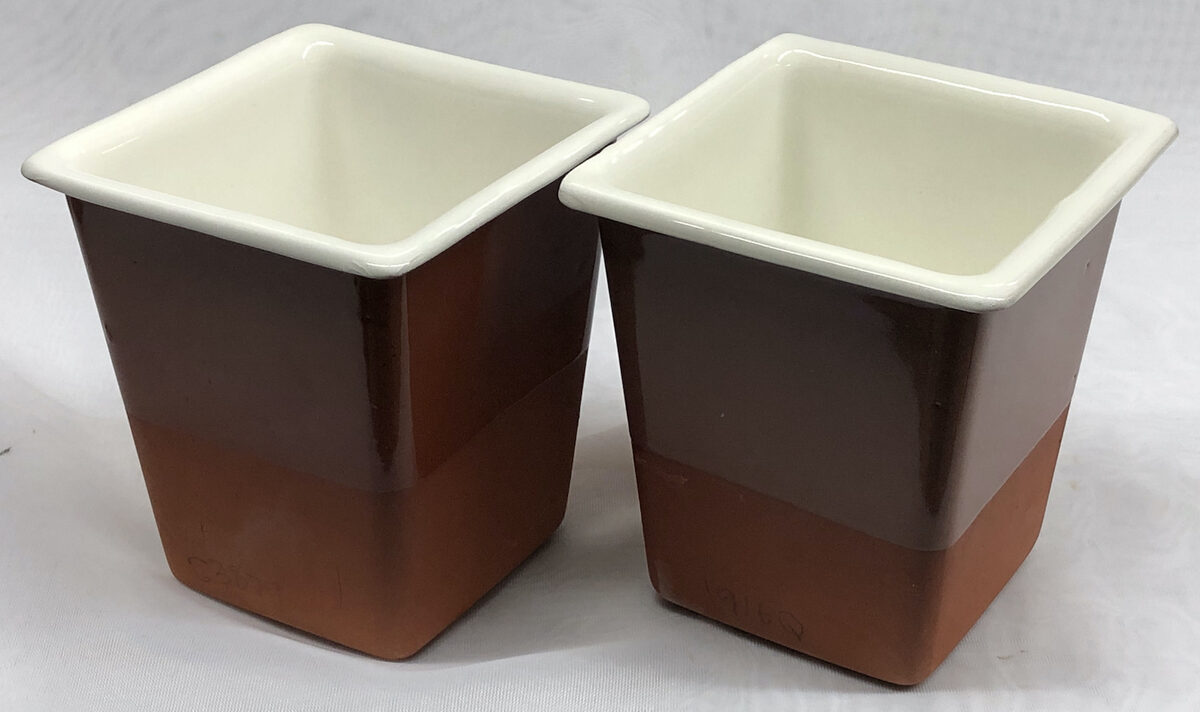 Two terra cotta slip-cast vessels with white inner surface