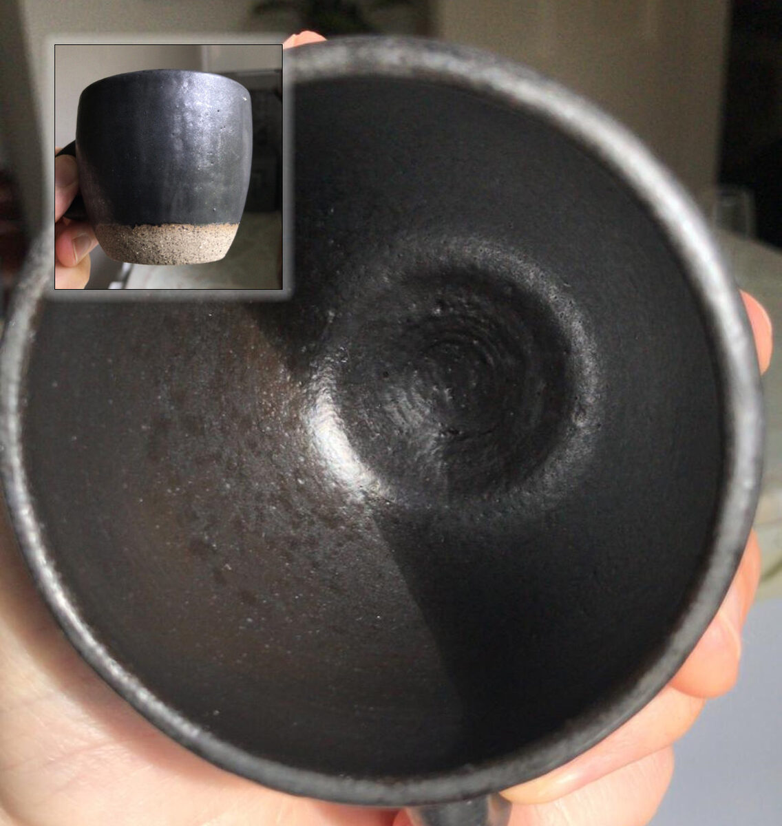 A matte black coffee mug with leaching glaze