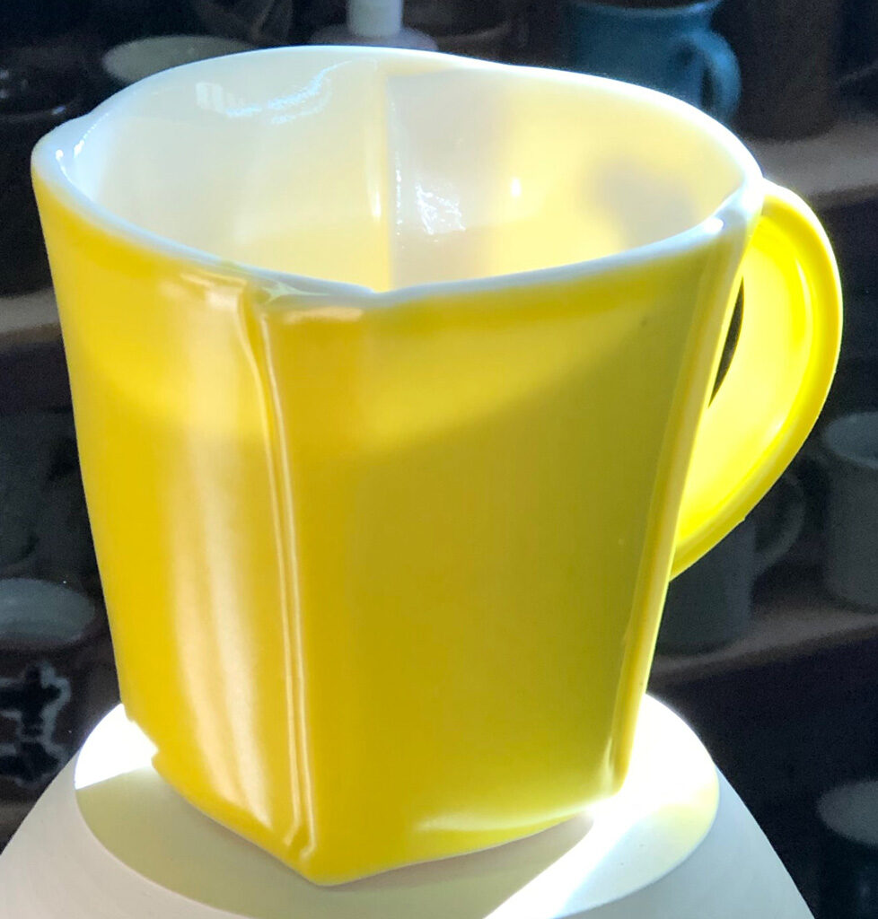 The lab-built porcelain mug really shows off its translucency in sunlight! A slab-built porcelain mug with yellow glaze showing off its translucency in sunlight