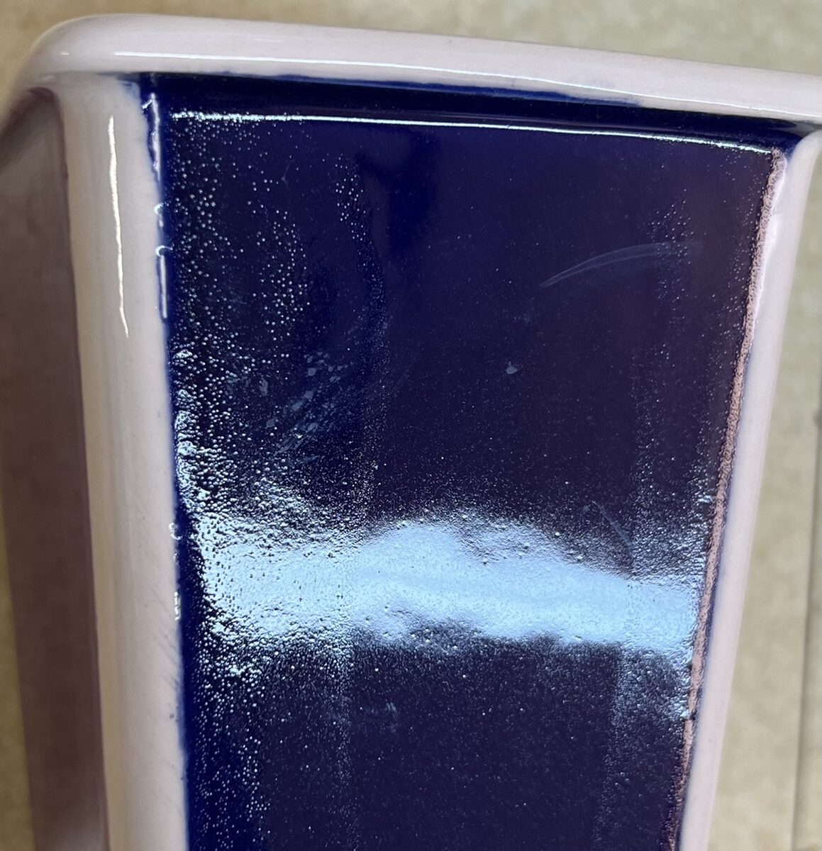 Wax resist affecting fired glaze surface