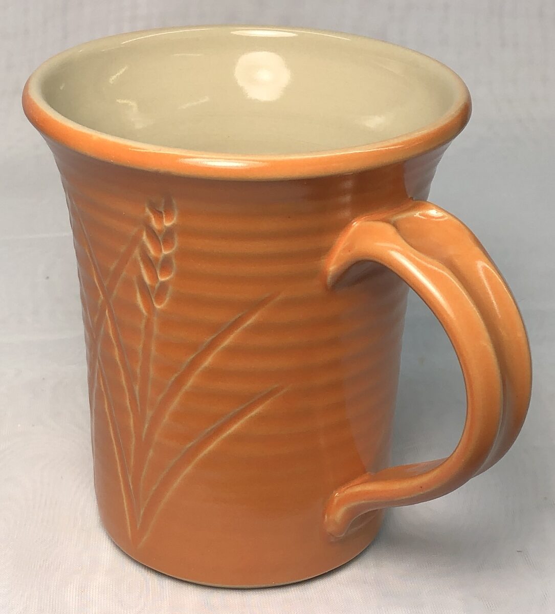 A hand made pottery mug with clear liner glaze
