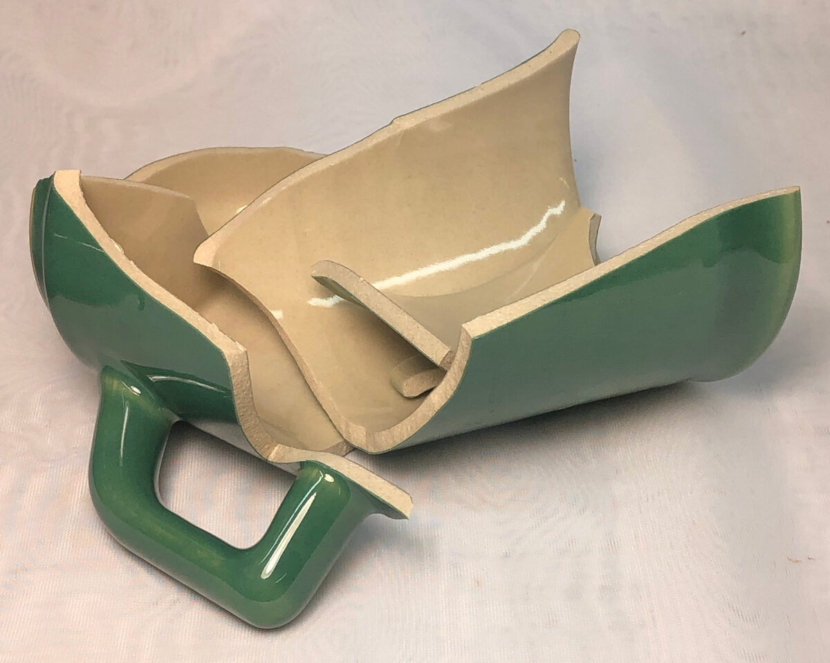 A broken slip cast cone 6 mug
