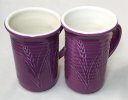 The glaze has 10% Mason 6304 purple stain and 2% zircopax to prevent bubbling Two purple-outside, white inside thrown Grolleg cone 6 porcelain mugs