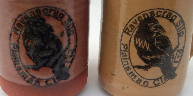 Two ceramic mugs with a rubber-stamped logo using a stain/glycerine ink Two ceramic mugs with a rubber-stamped logo using a stain/glycerine ink