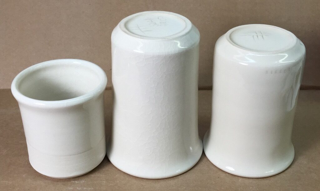 Thee porcelain mugs, the glaze on two are crazed
