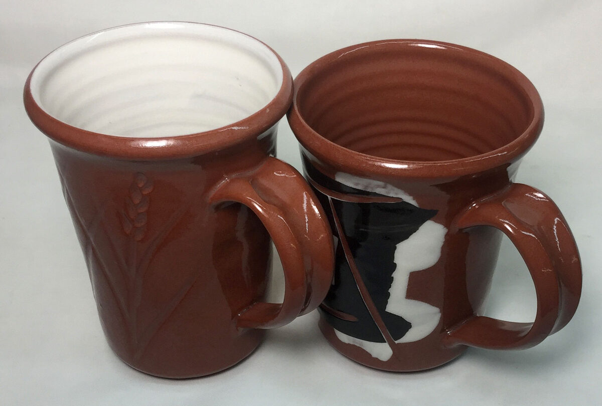 Two mugs, the one fired at cone 03 is better.